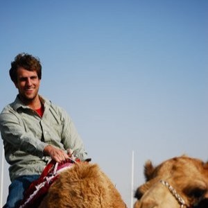 Hollin riding a camel